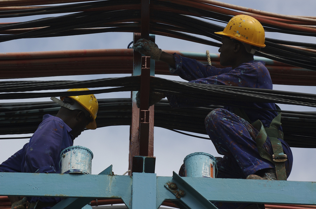 Workers maintain the thermal power station at Takoradi, Ghana, June 21, 2006. (Photo by Jonathan Ernst)